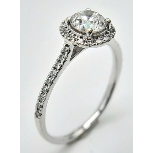 11 - AN 18K WHITE GOLD DIAMOND HALO SOLITAIRE RING 0.75CT MAIN STONE ROUND BRILIANT AND 0.25CT OF HALO & ... 