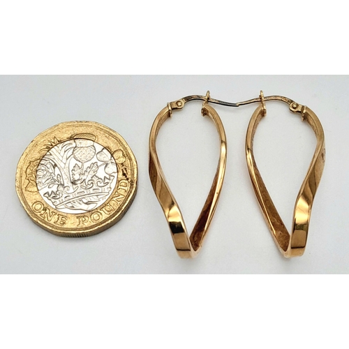 274 - A PAIR OF 9K GOLD CELTIC HOOP EARRINGS .  2.0gms