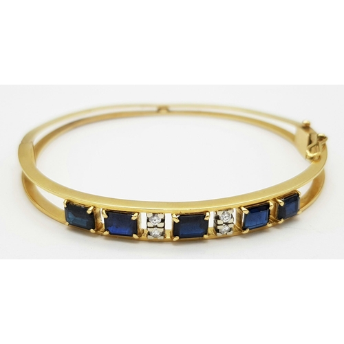 54 - A 14K (TESTED AS) YELLOW GOLD BANGLE SET WITH FIVE SAPPHIRES AND FOUR DIAMONDS, 6CM DIAMETER, 15.9G ... 