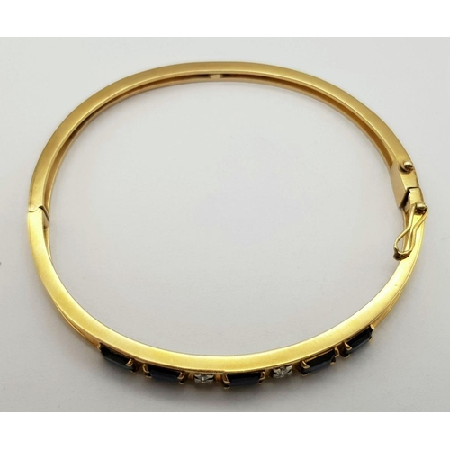 54 - A 14K (TESTED AS) YELLOW GOLD BANGLE SET WITH FIVE SAPPHIRES AND FOUR DIAMONDS, 6CM DIAMETER, 15.9G ... 