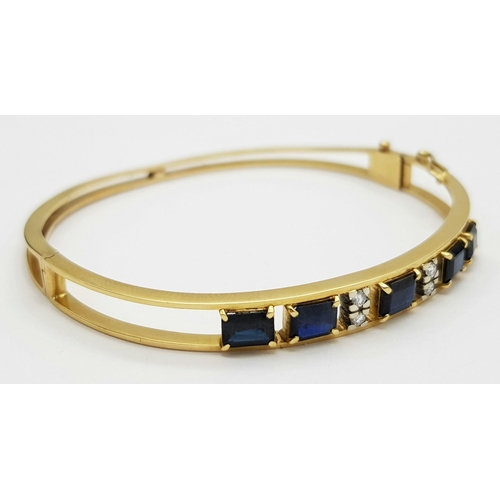 54 - A 14K (TESTED AS) YELLOW GOLD BANGLE SET WITH FIVE SAPPHIRES AND FOUR DIAMONDS, 6CM DIAMETER, 15.9G ... 