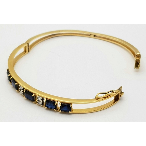 54 - A 14K (TESTED AS) YELLOW GOLD BANGLE SET WITH FIVE SAPPHIRES AND FOUR DIAMONDS, 6CM DIAMETER, 15.9G ... 