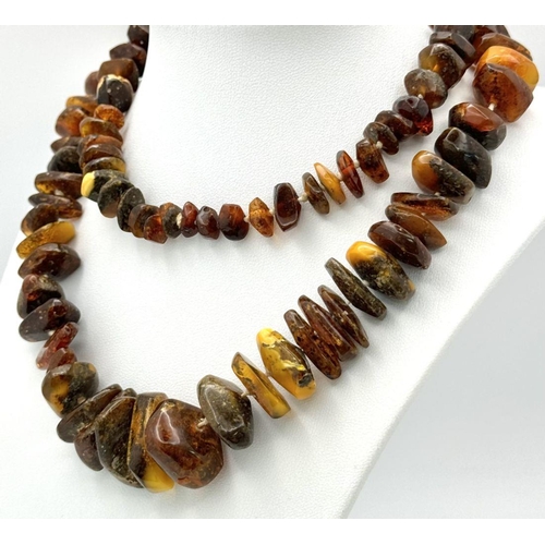 219 - A Vintage Amber Graduating Bead Necklace. Irregular shaped chips of amber. Please see UV light pictu... 