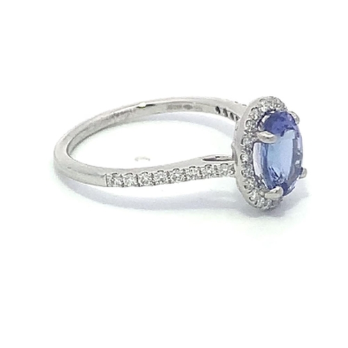 172 - A Platinum TANZANITE and DIAMOND halo ring. 1.41ct claw set oval shape Tanzanite centre, decorated w... 