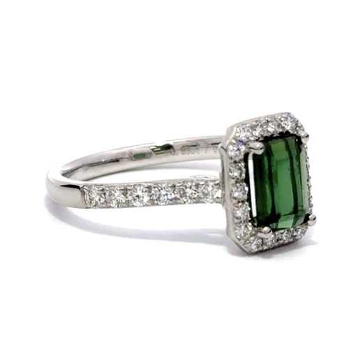 239 - A Platinum GREEN TOURMALINE and DIAMOND Halo Ring. 0.99ct claw set emerald shape Green Tourmaline ce... 