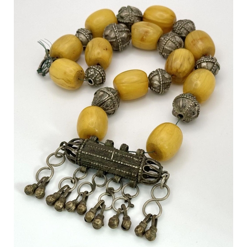 205 - A Vintage Tribal Butterscotch Large Barrel Bead Amber Necklace. Decorative white metal spacers and c... 