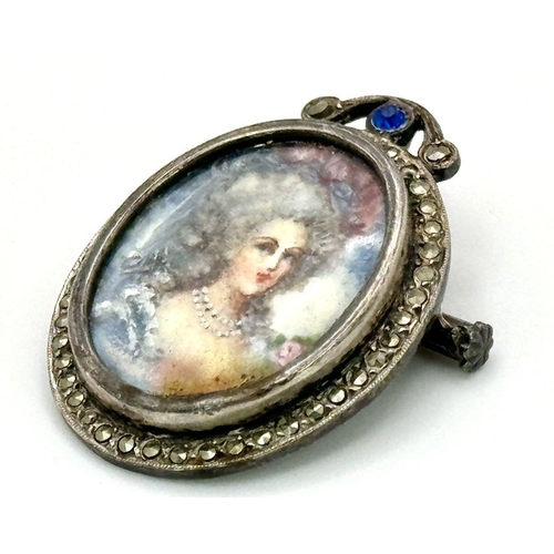 227 - An Antique Silver and Marcasite Oval Brooch/Pendant. Hand-painted portrait of a lady. 3.5cm.