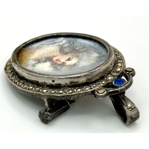 227 - An Antique Silver and Marcasite Oval Brooch/Pendant. Hand-painted portrait of a lady. 3.5cm.