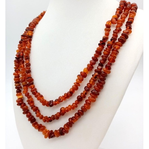 212 - A Rope Length Amber Chip Necklace. Please see UV light pictures to aid in authenticity. 160cm. 36g