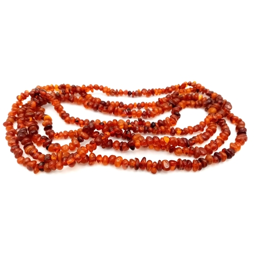 212 - A Rope Length Amber Chip Necklace. Please see UV light pictures to aid in authenticity. 160cm. 36g