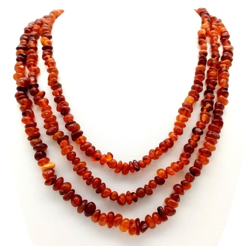 212 - A Rope Length Amber Chip Necklace. Please see UV light pictures to aid in authenticity. 160cm. 36g