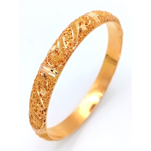 213 - A Beautifully Constructed 21K Yellow Gold Asian Decorative Filigree Bangle. 7cm inner diameter. 19.4... 