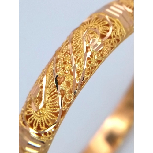 213 - A Beautifully Constructed 21K Yellow Gold Asian Decorative Filigree Bangle. 7cm inner diameter. 19.4... 