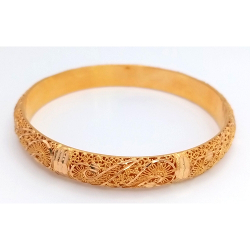 213 - A Beautifully Constructed 21K Yellow Gold Asian Decorative Filigree Bangle. 7cm inner diameter. 19.4... 