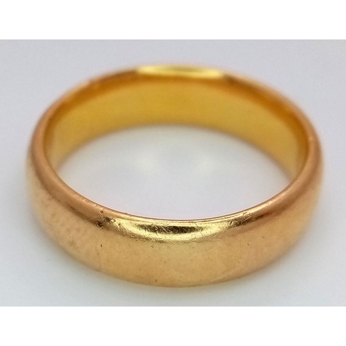 16 - A Classic 22K Yellow Gold Band Ring. 5mm width. Size P. 9.3g total weight. Full UK hallmarks.