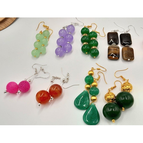 160 - An eclectic collection of twelve pairs of earrings all with stones. Examples include jade, carnelian... 