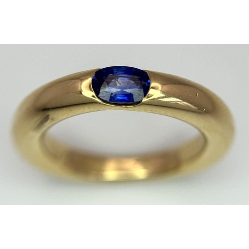 19 - An 18K Yellow Gold Cartier Ellipse Sapphire Band Ring. Size N. 9.2g total weight. Comes with origina... 