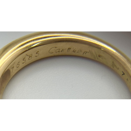 19 - An 18K Yellow Gold Cartier Ellipse Sapphire Band Ring. Size N. 9.2g total weight. Comes with origina... 