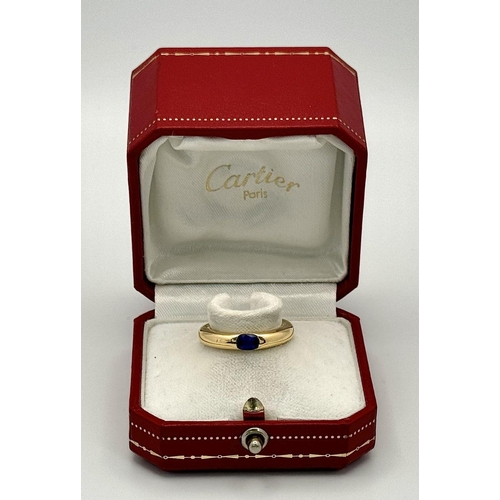 19 - An 18K Yellow Gold Cartier Ellipse Sapphire Band Ring. Size N. 9.2g total weight. Comes with origina... 