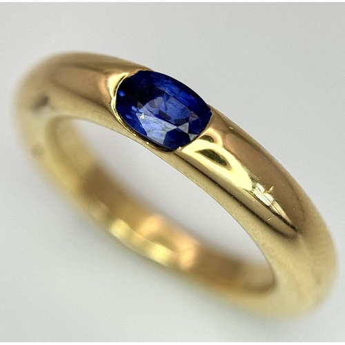 19 - An 18K Yellow Gold Cartier Ellipse Sapphire Band Ring. Size N. 9.2g total weight. Comes with origina... 