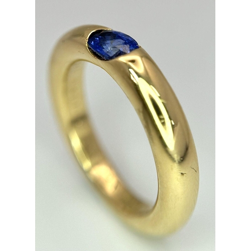 19 - An 18K Yellow Gold Cartier Ellipse Sapphire Band Ring. Size N. 9.2g total weight. Comes with origina... 
