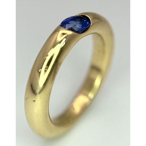 19 - An 18K Yellow Gold Cartier Ellipse Sapphire Band Ring. Size N. 9.2g total weight. Comes with origina... 