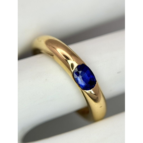 19 - An 18K Yellow Gold Cartier Ellipse Sapphire Band Ring. Size N. 9.2g total weight. Comes with origina... 