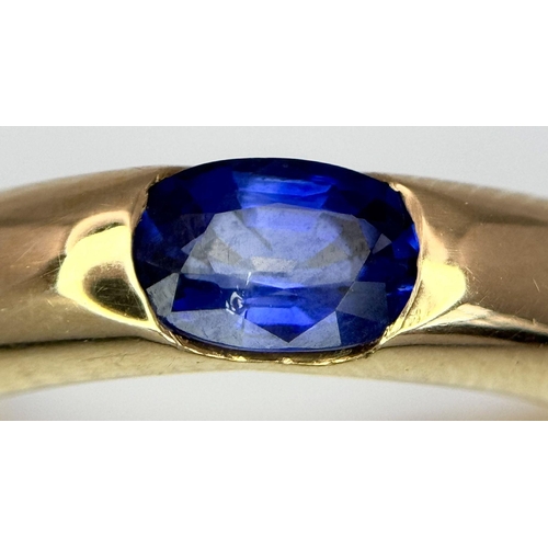 19 - An 18K Yellow Gold Cartier Ellipse Sapphire Band Ring. Size N. 9.2g total weight. Comes with origina... 