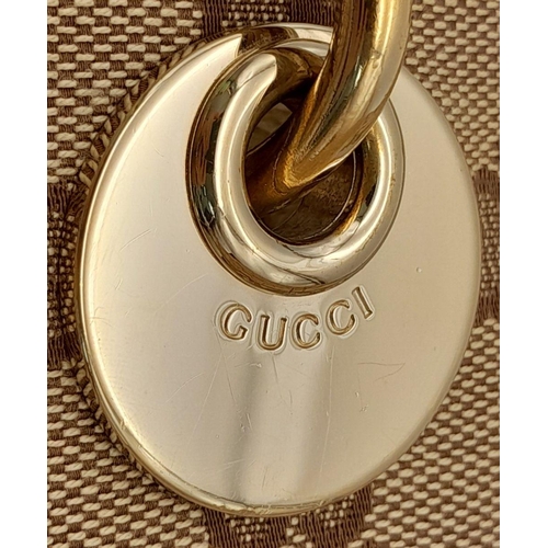250 - A Gucci Brown/Beige Eclipse Tote Bag. Textile exterior with leather trim, gold-toned hardware, four ... 