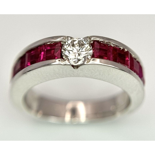 282 - An 18K White Gold Ruby and Diamond Ring. A central 0.25ct brilliant round cut diamond with four squa... 