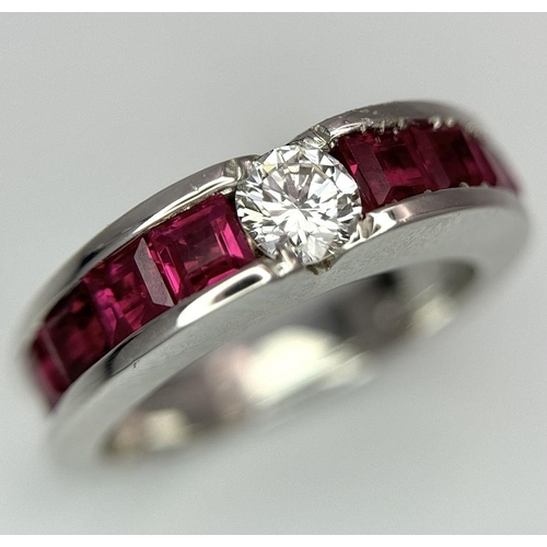 282 - An 18K White Gold Ruby and Diamond Ring. A central 0.25ct brilliant round cut diamond with four squa... 