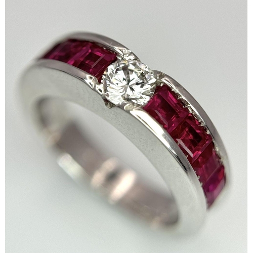282 - An 18K White Gold Ruby and Diamond Ring. A central 0.25ct brilliant round cut diamond with four squa... 