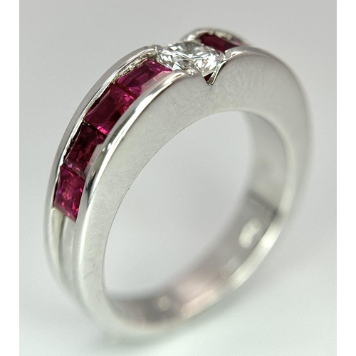 282 - An 18K White Gold Ruby and Diamond Ring. A central 0.25ct brilliant round cut diamond with four squa... 