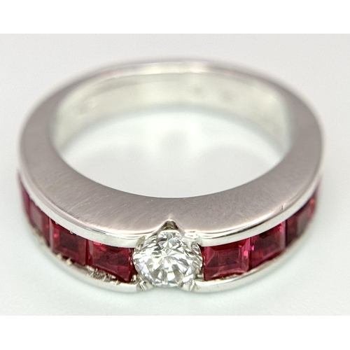 282 - An 18K White Gold Ruby and Diamond Ring. A central 0.25ct brilliant round cut diamond with four squa... 