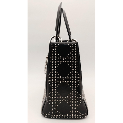 43 - A Christian Dior Black Lady Dior Handbag. Leather exterior with silver-toned hardware, stud embellis... 