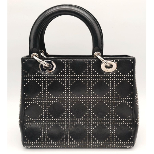 43 - A Christian Dior Black Lady Dior Handbag. Leather exterior with silver-toned hardware, stud embellis... 