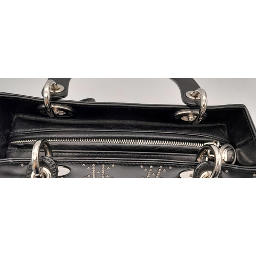 43 - A Christian Dior Black Lady Dior Handbag. Leather exterior with silver-toned hardware, stud embellis... 