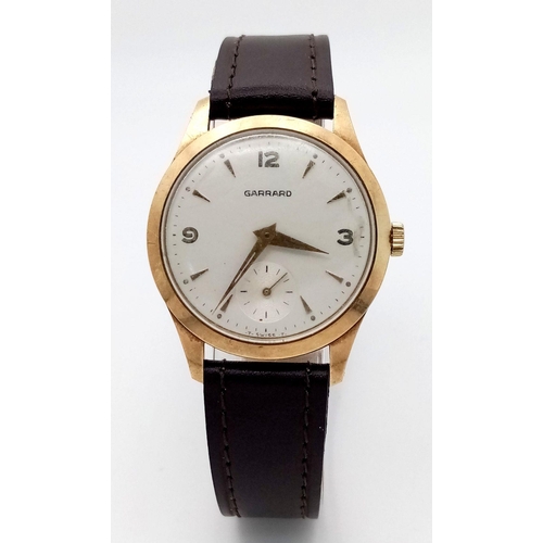 45 - A Vintage 9K Yellow Gold Garrard Gents Watch. New brown leather strap. 9K gold case - 31mm. White di... 