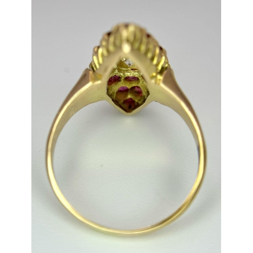 512 - A 14K Yellow Gold Ruby and Diamond Ring. Central diamond surrounded by 15 rubies in a marquise shape... 