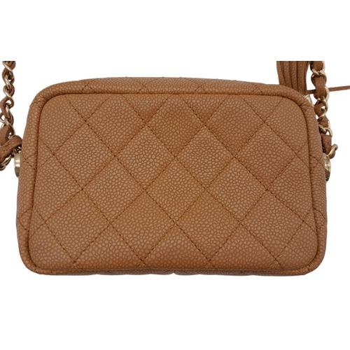 64 - A Chanel Tan Mini Coco Camera Tassel Crossbody Bag. Quilted caviar leather exterior with gold-toned ... 