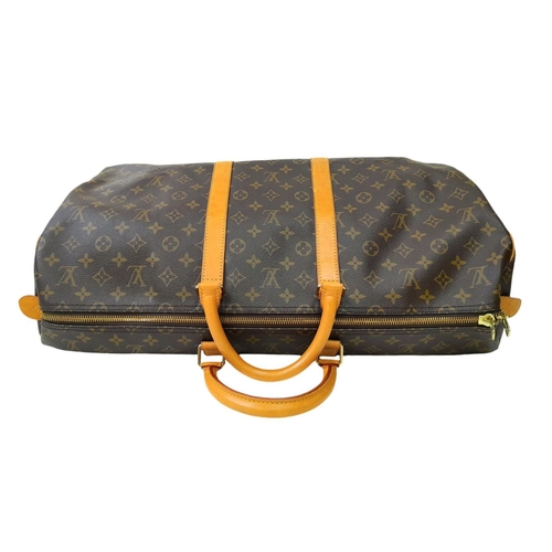 101 - A Louis Vuitton Keepall 55 Travel Bag. Monogram coated canvas exterior with leather trim, two rolled... 