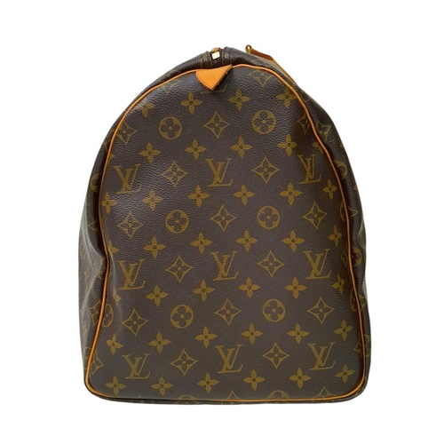 101 - A Louis Vuitton Keepall 55 Travel Bag. Monogram coated canvas exterior with leather trim, two rolled... 