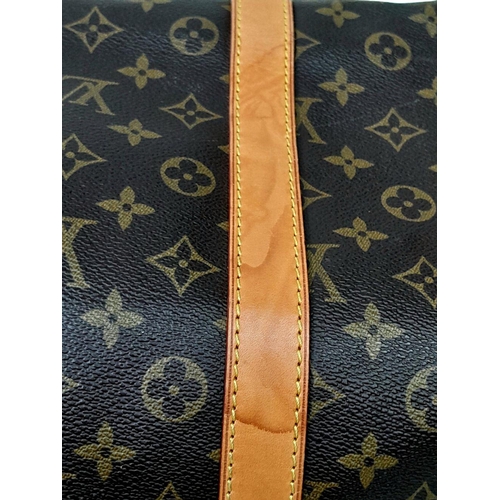 101 - A Louis Vuitton Keepall 55 Travel Bag. Monogram coated canvas exterior with leather trim, two rolled... 