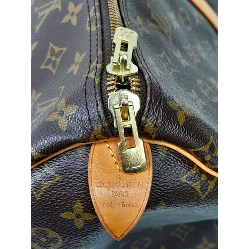 101 - A Louis Vuitton Keepall 55 Travel Bag. Monogram coated canvas exterior with leather trim, two rolled... 