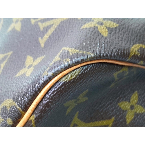 101 - A Louis Vuitton Keepall 55 Travel Bag. Monogram coated canvas exterior with leather trim, two rolled... 