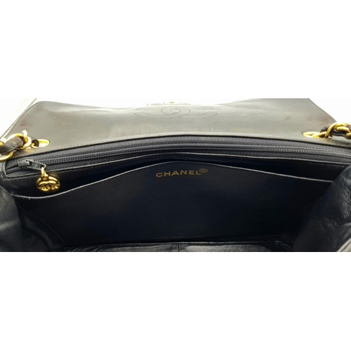 29 - A Chanel Black Crossbody Bag. Matelassé leather exterior with gold-toned hardware, chain and leather... 