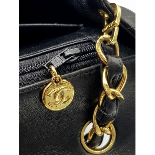 29 - A Chanel Black Crossbody Bag. Matelassé leather exterior with gold-toned hardware, chain and leather... 