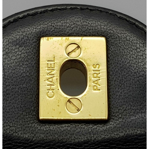 29 - A Chanel Black Crossbody Bag. Matelassé leather exterior with gold-toned hardware, chain and leather... 