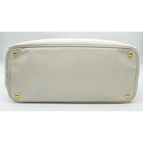 57 - A Prada Cream Galleria Handbag. Saffiano leather exterior with gold-toned hardware, two rolled handl... 