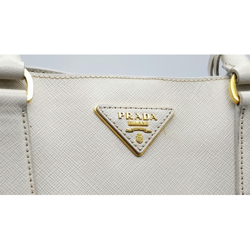 57 - A Prada Cream Galleria Handbag. Saffiano leather exterior with gold-toned hardware, two rolled handl... 